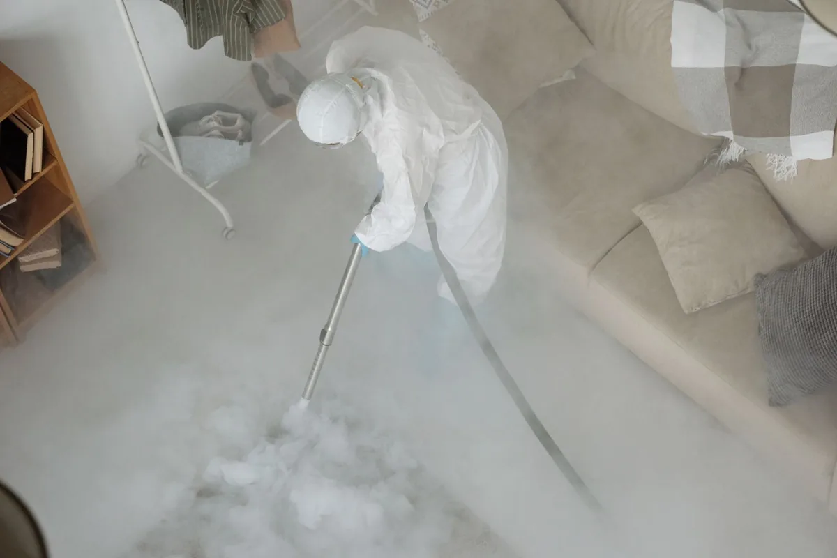 Biohazard cleanup technician in protective equipment, Grant, MN